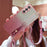 For Samsung Galaxy S25 Case Electroplated Glitter Hand Strap Kickstand TPU Back Cover with Shoulder Strap - Pink - 1