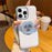 For iPhone 16 Pro Max Magnetic Case Rotating Kickstand Gear Stress Relief Leather Phone Back Cover - White - 1