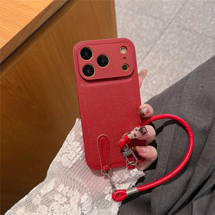 For iPhone 17 Pro Case TPU PU Leather PC Anti-drop Phone Back Cover with Wrist Strap - Red Leather Strip - 2