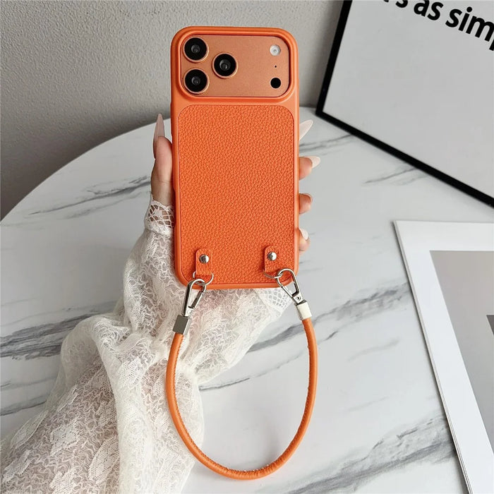 For iPhone 17 Pro Case Metal Paint Litchi Texture PU Leather Phone Back Cover with Wrist Strap - Orange - 1
